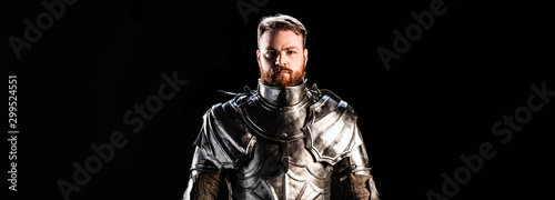 Fotomural panoramic shot of handsome knight in armor isolated on black