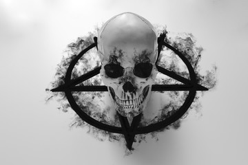 White human skull on top of black pentagram on white background with black smoke