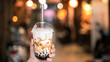 © RomixImage - Young woman is holding, drinking brown sugar flavored tapioca pearl bubble milk tea with glass straw in night market of Taiwan, close up, bokeh