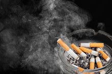 Ashtray And Smoked Cigarettes On Backgrouund