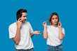 © ianachyrva - Blond woman and brunet man in white tees and blue jeans are talking on the phone.