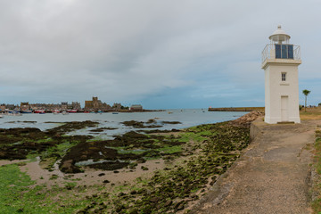 Poster - the Barfleur harbor lighthouse and port at low tide in the evening