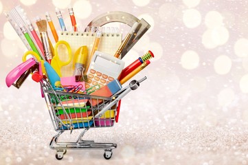 Wall Mural - Shopping cart with colorful school stationery, back to school background