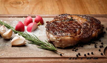 steak from beef, steak with vegetables, proper nutrition, healthy food,  a piece of boiled pork on a wooden board, presentation and serving, rustic style, vegetables for meat, 