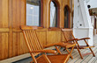 Wooden deck chairs on teak promenade on luxury sailing windjammer Sea Cloud yacht