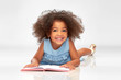 © Syda Productions - childhood, school and education concept - happy smiling little african american girl reading book over grey background