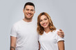 © Syda Productions - relationships and people concept - portrait of happy couple in white t-shirts over grey background