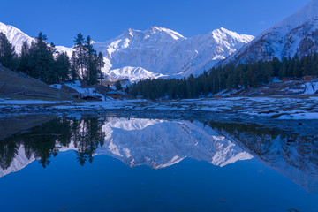 Water reflection of Fairy meadows during the sunset period with  Nanga parbat mountain range , gilgit-baltistan , Pakistan