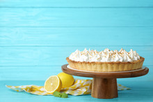 Stand With Delicious Lemon Meringue Pie On Blue Wooden Table, Space For Text