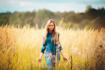 People success freedom concept - Fashion portrait of beautiful smiling young blonde Caucasian girl women watching with her perfect eyes outdoor in the park wheat field outdoor at summer in sunlight