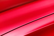 Red car bodywork, detail of hood and fender of sport sedan, automobile industry, selective focus, abstract