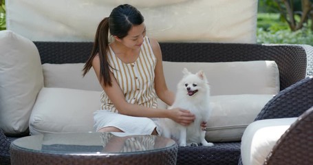 Canvas Print - Woman play with her dog at hotel resort house