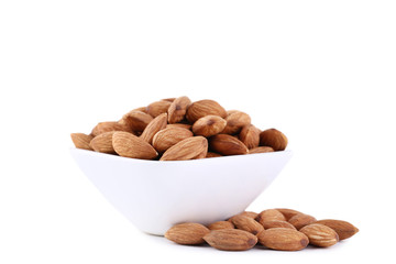 Almonds in bowl isolated on white background