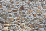 Fototapeta Desenie - Stone wall of rough unprocessed stones