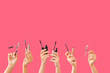 © Pixel-Shot - Many hands with mascara and eyelash curlers on color background
