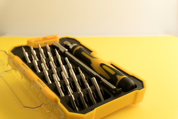 Interchangeable screwdriver set with different types of metal steel heads and bits. Isolated on white background.