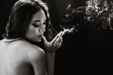 Sexy Woman Smoking Cigarette With Smoke Black Space For Text Low Key.