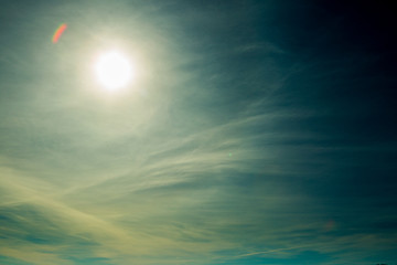 bright blue sky with the sun causing lens flare