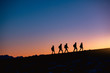 © cppzone - Group of hikers at sunset mountain