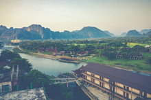 Aerial View Of Village Vang Vieng And  Nam Song River , Laos. Southeast Asia. Photo Made By Drone From Above. Bird Eye View.