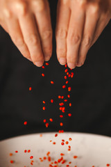 Wall Mural - Seeds of red lentils, female hands take grains.