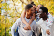 © AS Photo Family - Four african friends walking the streets of an ancient city at autumn sunny day.