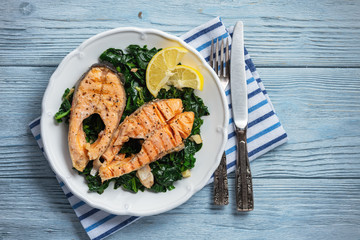 Wall Mural - Grilled rainbow trout fillet, served with spinach.