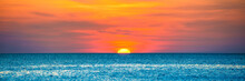 Panorama Of Nature Landscape With Beautiful Dramatic Orange Sunset Over Blue Wave Sea