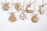 Fototapeta Na drzwi - Christmas gingerbread of different kinds on a black and white wooden background