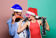 Happy Man And Woman Wear Santa Hats And Funny Sunglasses. Cheerful Couple Celebrate New Year. Corporate Holiday Party Ideas. Christmas Party Office. Winter Corporate Party. Office Christmas Party