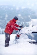 Snow Covered Car On A Cold Winter Day..man Cleaning Frozen Car Covered Snow At Winter Day,