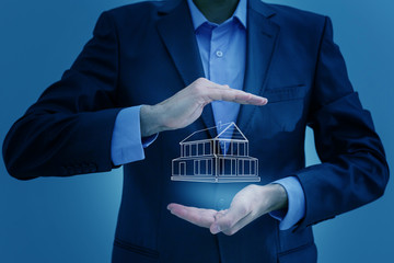 Poster - Real estate offer. Businessman holds an artificial model of the house