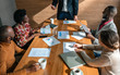 © JonoErasmus - Close up of boardroom meeting. Multi ethnic coworkers in business strategy meeting