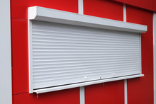 White Roller Shutters At A Red Kiosk. Street Retail, Shop, Market. Modern Safety And Security.