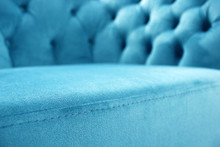 Detail Of Classical Furniture, Selective Focus. Velour Sofa Close-up With Part Of The Seat. Turquoise Padded Fabric Upholstery Of The Sofa. Turquoise Velvet With Buttons On The Upholstered Furniture.