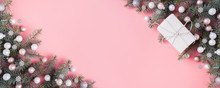 Christmas Silver Pink Glass Ball And Fir Branches On Pink. Xmas Banner With Space For Text. View From Above.