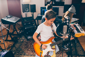 Wall Mural - kids rock band playing in music studio