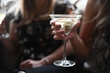 © Anna Petrow - Close up of woman holding cocktail drink