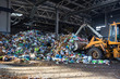 excavator stacks trash in big pile at sorting modern waste recycling processing plant. Separate and sorting garbage collection. Recycling and storage of waste