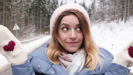 Poster - Beautiful young woman showing different emotions on road in snowy forest