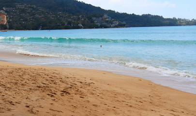 Wall Mural - view of patong beach in phuket, sea waves roll on the sandy shore, foam and spray of water