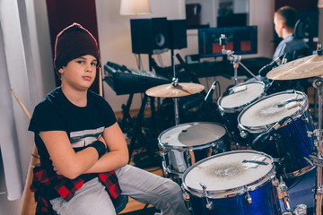 Wall Mural - boy drummer crossed arms in music studio