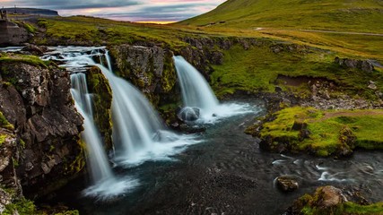 Wall Mural - VIDEO LOOP SEAMLESS: Iceland timelapse photography of famous waterfall and mountain. Kirkjufellsfoss and Kirkjufell in northern Iceland nature landscape. Time lapse video in 4K - looping video.