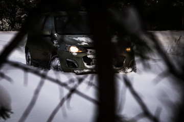 Wall Mural - a car makes its way through fresh snow