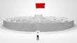 © ra2 studio - Man standing in front of a big round maze with flag