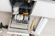 Home Dishwasher appliance being repaired in a kitchen
