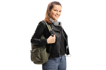 Canvas Print - Female student with a backpack and headphones aroung her neck