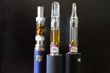 Vape Pens And Cartridges With A Dark Background.