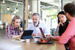 © Westend61 - Casual business people having a meeting in a cafe