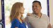 © Mark Adams - older Caucasian and African American couple standing in their kitchen smiling